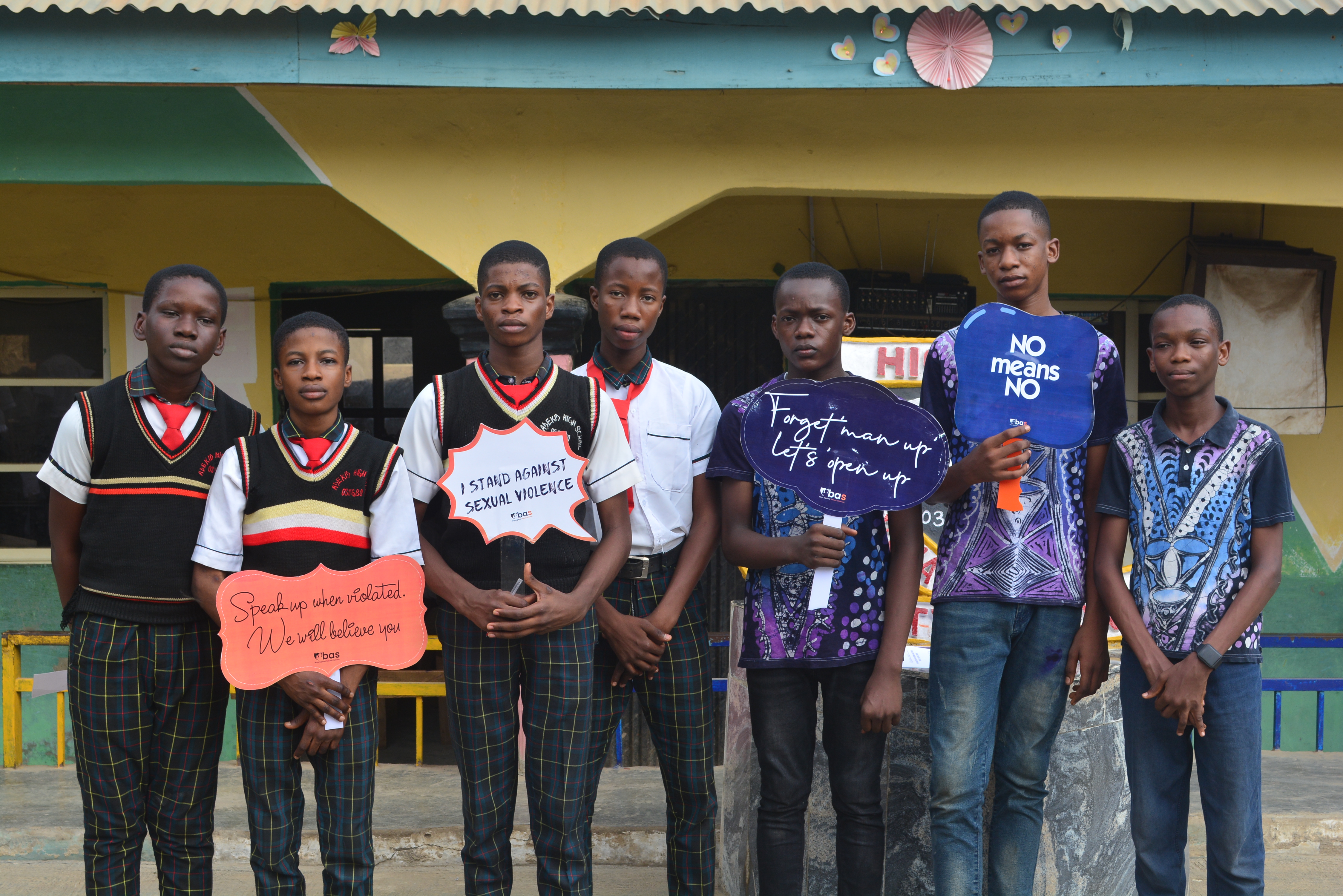 Boys standing together with sexual violence prevention messages